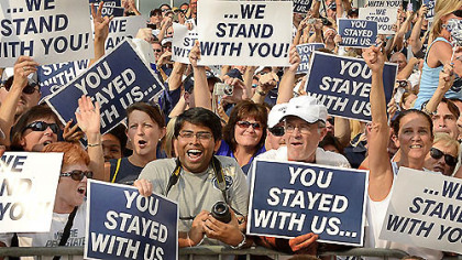 Penn State fans cheer as head coach Bill O'Brien and the football team arrive prior to their game against Ohio University at Beaver Stadium in State College.