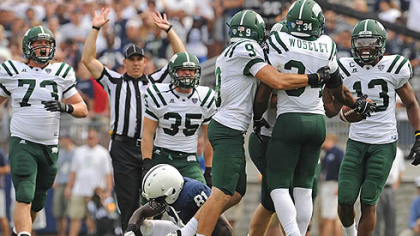 Ohio University players celebrate after linebacker Jelani Woseley intercepted a Penn State pass late in the fourth quarter to seal the win against the hosting Nittany Lions at Beaver Stadium in State College this afternoon.