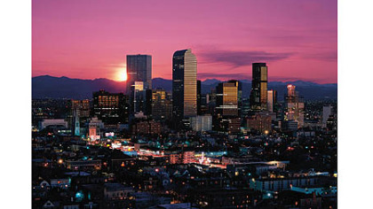 The skyline of Denver against the Rocky Mountains.