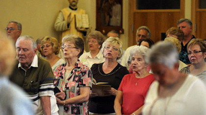 Worhsipers during the vigil Mass for the Feast of the Assumption at St. Elizabeth Ann Seton in Carnegie.