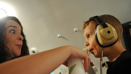 Research technician Jenna El-Wagaa administers a test to 5-year-old Peter Strobl inside a pressure chamber.