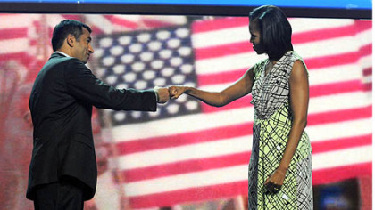 Actor Kal Penn, left,  jabs fists with first lady Michelle Obama during an interview at the Time Warner Cable Arena before the official start of the Democratic National Convention in Charlotte.