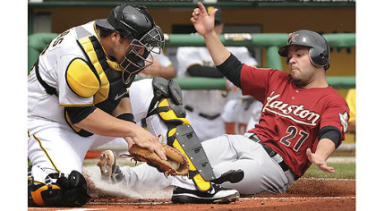 The Astros' Jose Altuve is forced out at home plate by Pirates catcher Rod Barajas Monday at PNC Park.