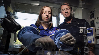 Jennifer Hayden, a biomedical engineering doctoral student at Carnegie Mellon, and neurosurgeon James Burgess work with the Aqueous Immersion Surgical System prototype to be tested under zero gravity through NASA.