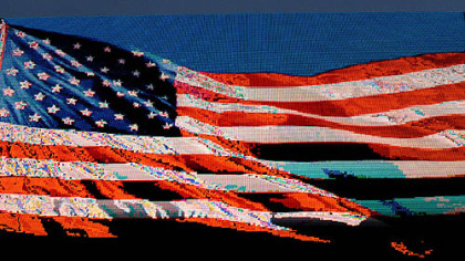 An electronic billboard flashes images of the American flag, welcoming delegates to the Charlotte Convention Center before the start of the Democratic National Convention in Charlotte, N.C., Sunday.