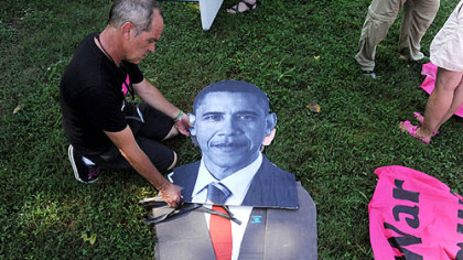 Tighe Barry of Los Angeles creates a cutout of President Barack Obama for the March on Wall Street South protest before the start of the Democratic National Convention in Charlotte, N.C., on Sunday.