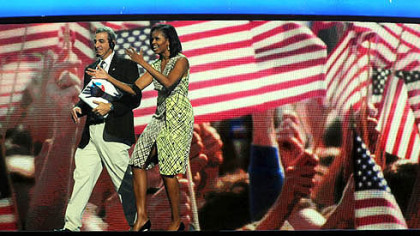 First lady Michelle Obama gets a feel for the stage inside of the Time Warner Cable Arena on Monday before the official start of the Democratic National Convention in Charlotte, N.C.