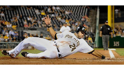 Pedro Alvarez reaches out to touch home as he slides safely past St. Louis catcher Tony Cruz.