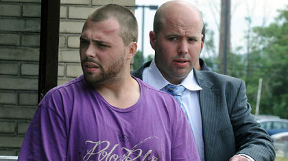 Jonathan Schaeffer of Crafton is escorted after questioning Wednesday afternoon at the Allegeny County police headquarters in Point Breeze. He is believed to be the suspect involved in a chase that injured two Avalon police officers.