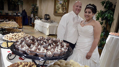 Brian Perris and Cristine Lazzaro at the cookie table celebrating their wedding.