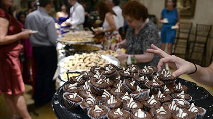Wedding guests line up to partake at a cookie table celebrating the wedding of Cristine Lazzaro and Brian Perris.