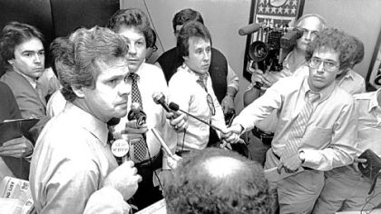 Father Dick Haley, then team director of player personnel, talks to the news media about the team's top draft choice, in 1982, Walter Abercrombie.
