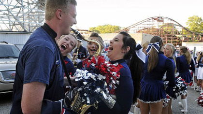 Shaler Area senior John Booker, 18, shows off a little saxophone to dance team members, from left, Madison Vaughan, 15, a sophomore; Katie Fischer, 16, a junior; and Rachel Dekleva, 17, a senior. The students were preparing to perform Aug. 18 during the 63rd annual Fall Fantasy Parade at Kennywood.