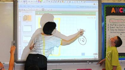 Fourth-grade math teacher Linda Ewonce teaches Cade Moffatt at Burkett Elementary School. The Montour School District has closed Ingram Elementary School and has consolidated all elementary grades into two buildings.