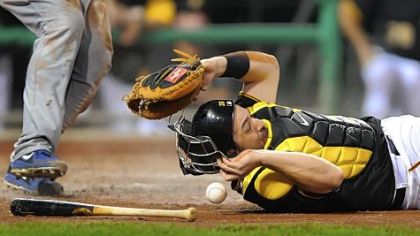 Catcher Rod Barajas hits the dirt missing the throw from first basemen Gabby Sanchez as the Cubs' Brett Jackson scores Friday night at PNC Park.