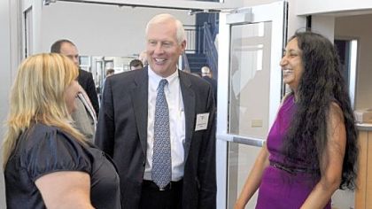 Penn State President Rodney Erickson talks with Lori Johnson, left, and professor Kausalai Wijekumar, right, after the dedication of the new wellness center at Penn State Beaver.