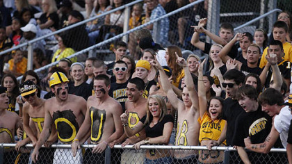 The Montour student cheering section yells for television cameras before the start of its game against Central Valley Thursday at Central Valley.