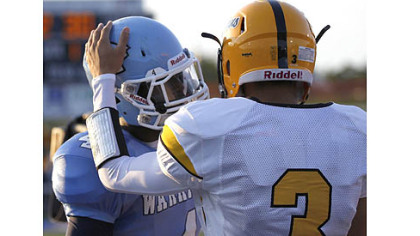 Montour receiver Devin Wilson, right, greets Central Valley receiver Robert Foster before the start of their game Thursday at Central Valley.