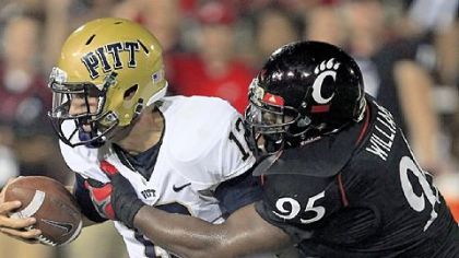 Pitt quarterback Tino Sunseri, left, is sacked by defensive lineman John Williams in the first half Thursday in Cincinnati.