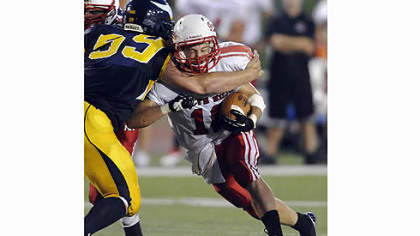 Central Catholic's Zack DeLuca takes down North Hills' Joshua Hulbert Friday night.