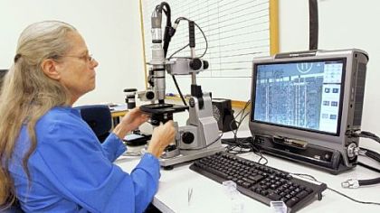 Loreen Parker, a counterfeit test operator at Integra Technologies in Wichita, Kan., looks for counterfeit integrated circuits. Integra Technologies is helping test devices for defense contractors to make sure weapons systems don't contain counterfeit parts.
