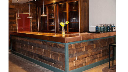 Todd Meyer of Swissvale used salvaged materials in a renovation of E? restaurant in Highland Park. His crew used reclaimed floor boards on the bar front.