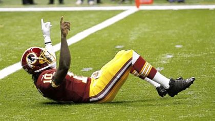 Redskins quarterback Robert Griffin III reacts after throwing a touchdown pass in the first quarter Sunday.