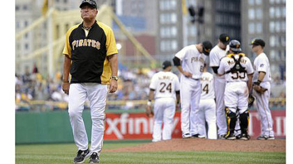 Pirates manager Clint Hurdle walks off the field after talking with pitcher Chad Quall in the 8th inning against the Cubs.