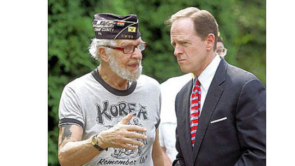 Sen. Pat Toomey, R-Pa., chats with Korean War veteran Robert Alper after speaking Thursday in Wilkes-Barre, in northeastern Pennsylvania. There he discussed a bill he introduced for a one-year pilot program to help veterans find jobs based on military experience. The program would provide new tools for veterans to find jobs online.
