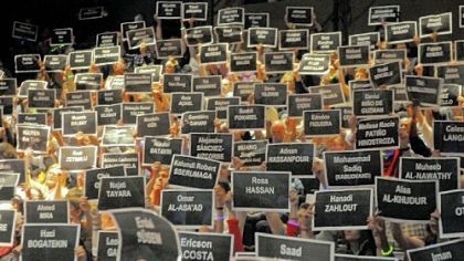 Signs with the names of persecuted writers around the world were raised during the City of Asylum Jazz Poetry concert.