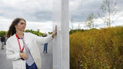 Melissa Taylor of Cincinnati runs her hand along the engraved wall of the Flight 93 National Memorial in Stonycreek, near Shanksville. She was at the memorial Monday to remember her husband's friend from the Air Force, Leroy Homer.