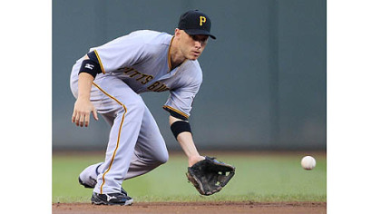 Pirates shortstop Clint Barmes fields a ground ball hit by the Reds' Brandon Phillips in the first inning in Cincinnati. Barmes threw Phillips out at first.