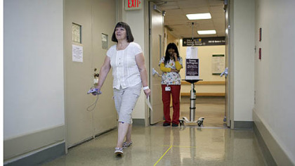 Brenda Warner, of Tyrone, Pa., participates in a walk test Tuesday as part of the CardioFit system clinical trial at Allegheny General Hospital. Warner is the first person in to receive the CardioFit implant as part of the trial.