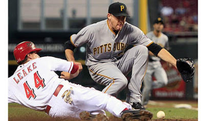 Cincinnati's Mike Leake scores on a wild pitch in the second inning. It was one of two runs to score on the play when Michael McKenry's throw to Kevin Correia kicked away, allowing Brandon Phillips to score.