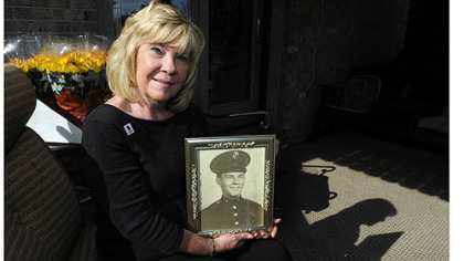 Marilyn Hendricks Claassen holds a portrait of her uncle Jack Yeager, a Marine tail gunner in World War II whose remains were found in the Pacific Islands in 2009 and are to be buried Saturday in New Kensington. Ms. Claassen wears his wedding ring on her right hand.