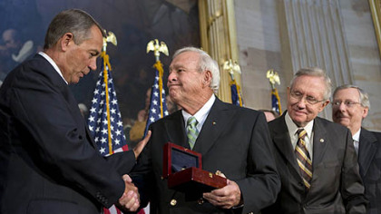 Arnold Palmer, center, receives the Congressional Gold Medal from House Speaker John Boehner, left, an avid golfer himself. At right is Senate Majority Leader Harry Reid.
