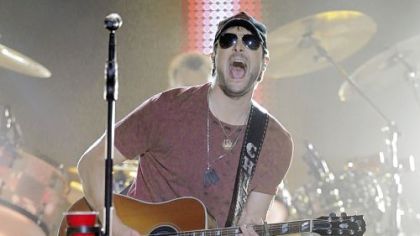Eric Church performing on an outdoor stage during the CMT Music Awards show in Nashville, Tenn.
