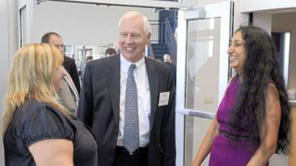 Penn State President Rodney Erickson talks with Lori Johnson, left, and professor Kausalai Wijekumar, right, after the dedication of the new wellness center at Penn State Beaver.