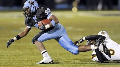 Seneca Valley's Forrest Barnes runs for a first down as he's taken down by North Allegheny's Elijah Zeise in September 2011. North Allegheny won, 49-28.