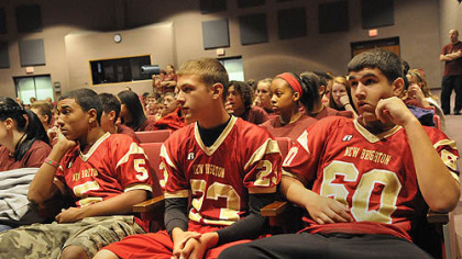 Three members of the junior high football team from New Brighton Middle School, left-right Robert Gibbons, 14, Brendon Duschene, 14, and Matthew Hall, 14, wait for the start of a program about Rachel's Challenge, created to use the life and writings of Rachel Joy Scott, who was the first victim in the 1999 Columbine school shootings, to encourage people to treat each other with respect.