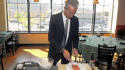 Maitre d' Dave Cesaro prepares steak tartare at Bridge Ten Brasserie.