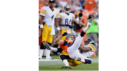 Cortez Allen hauls down the Broncos' Brandon Stokley Sunday in Denver.