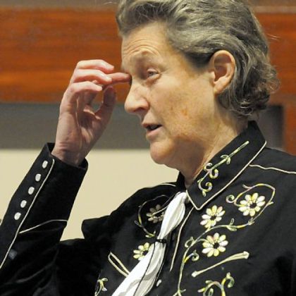 Temple Grandin, shown during an appearance here earlier this year, says taking dogs off a leash lets them know it is time to play.