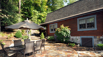 Side exterior with a stone patio