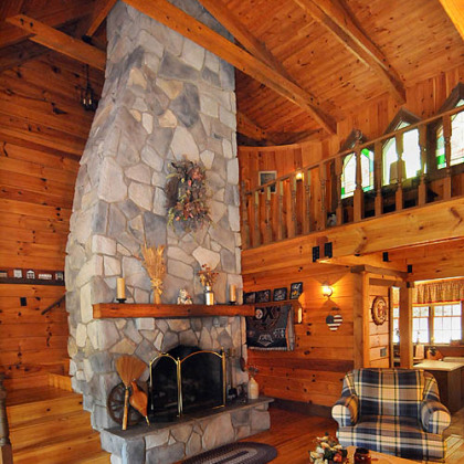 A feature of the two-story living room with balcony is the fireplace.