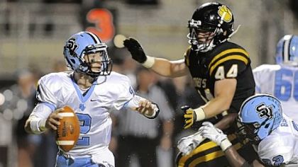 Seneca Valley quarterback Jordan Brown scrambles Friday as he's defended by North Allegheny's Kevin Edwards.