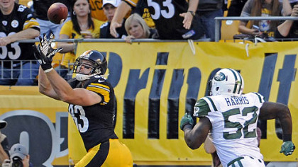 The Steelers' Heath Miller pulls in a pass for a touchdown as he's defended by the Jets' David Harris in the second quarter at Heinz Field.