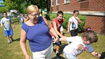 Classroom aide Connie Lewis plays with Alessandra Vacchio, 10, at the West Virginia School for the Deaf in Romney, W.Va.