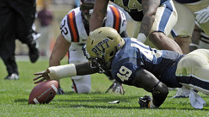 Pitt's Eric Williams reaches to recover a fumble against Virginia Tech in the second quarter of today's game at Heinz Field.