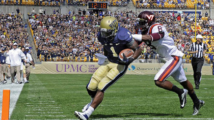 Pitt's Ray Graham scores a touchdown as he's defended by Virginia Tech's Detrick Bonner in the first quarter today at Heinz Field.
